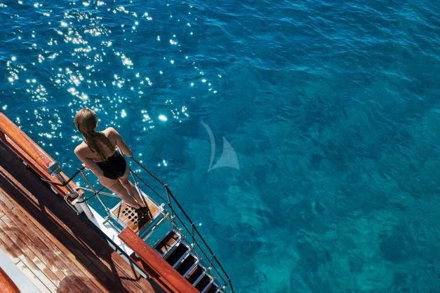 a person jumping into a pool aboard CORSARIO Yacht for Charter