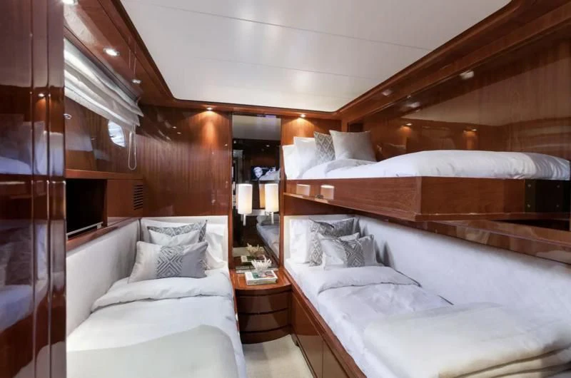 a room with a bed and a wood wall aboard ZEN Yacht for Sale