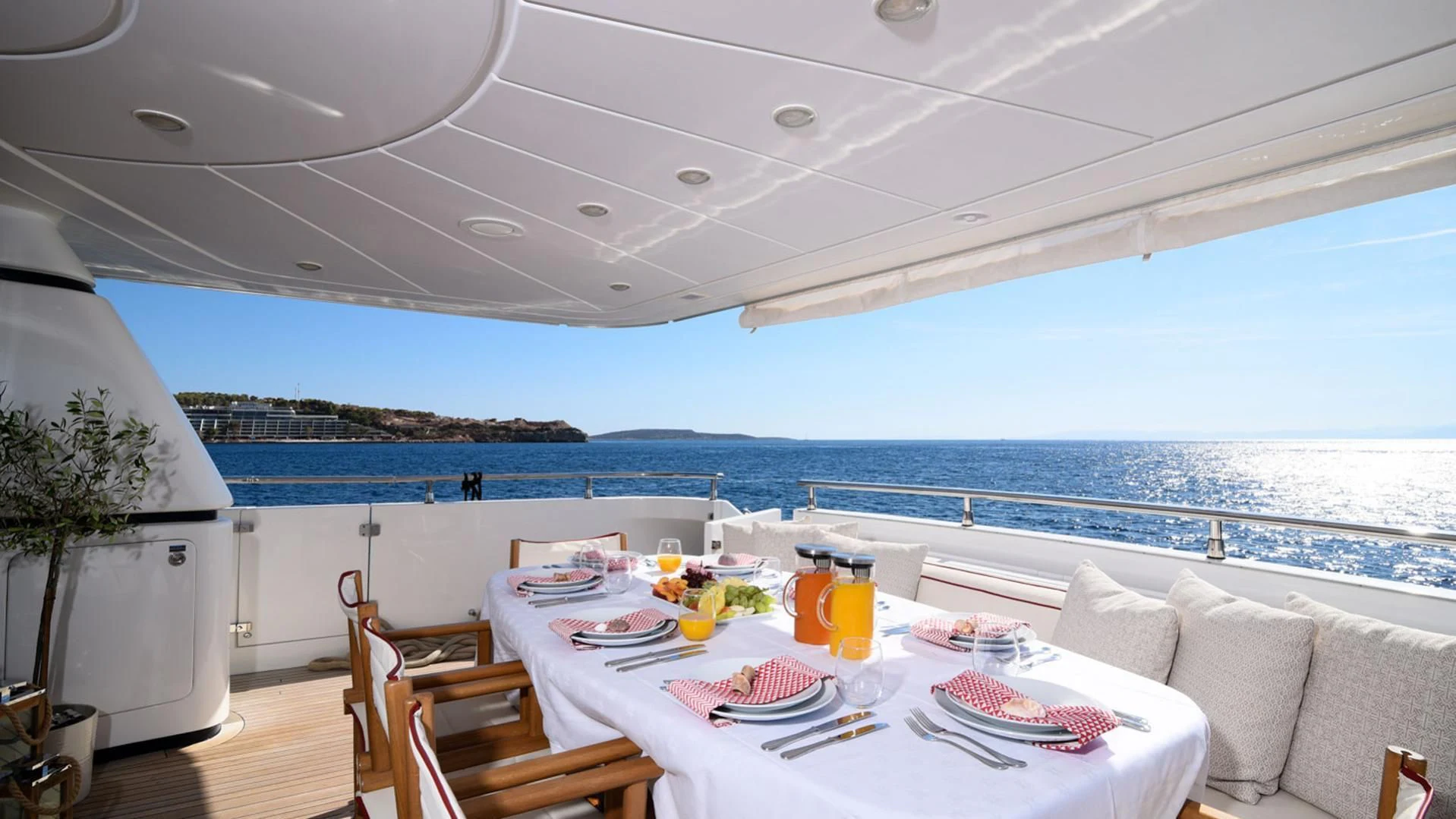 a table set for a meal on a deck overlooking the ocean aboard ZEN Yacht for Sale