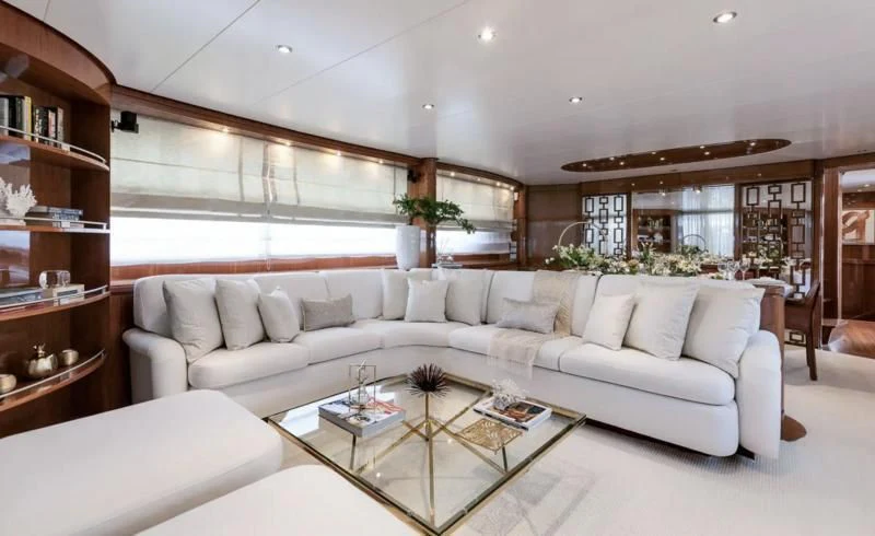 a living room with a white couch aboard ZEN Yacht for Sale