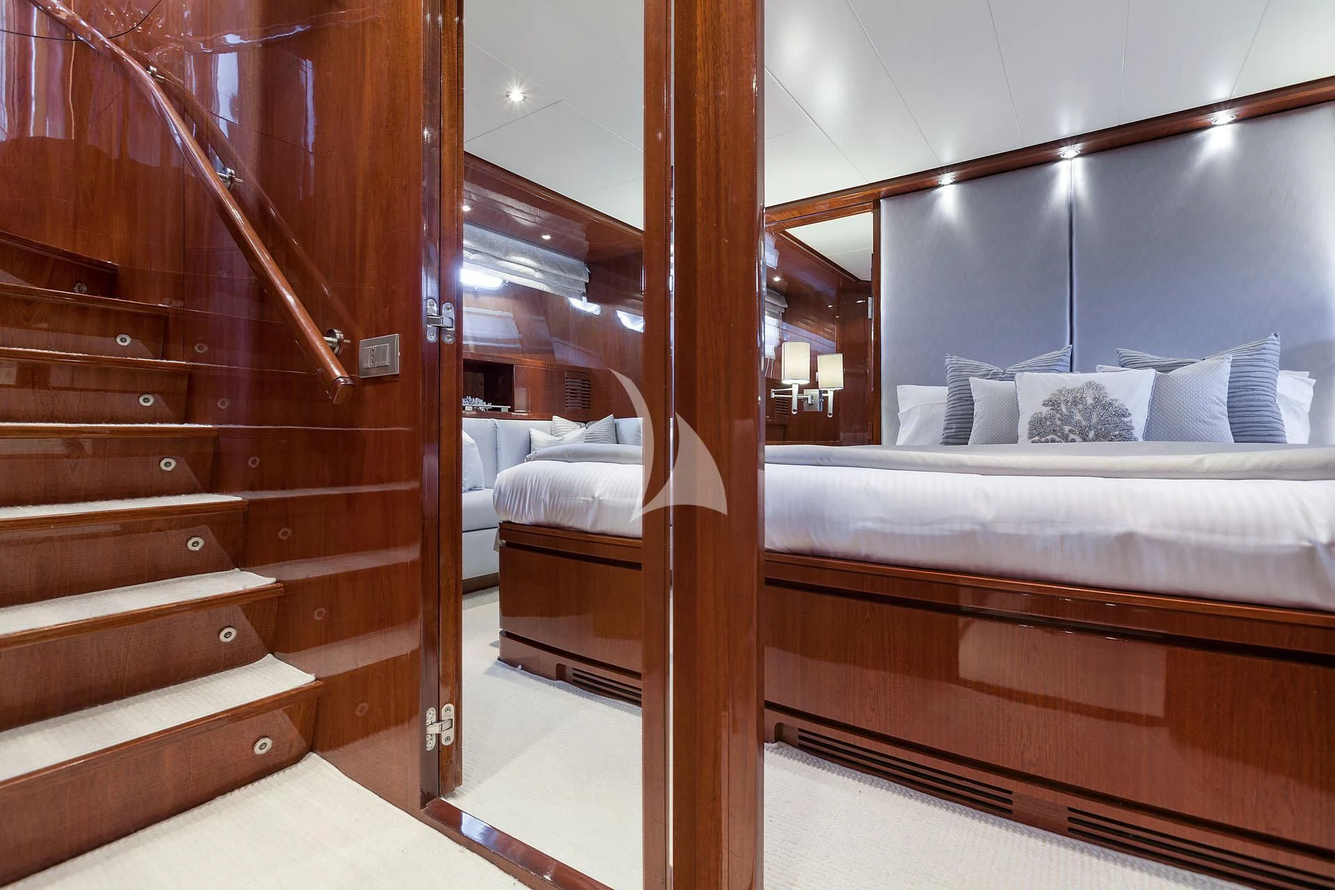 a room with a bed and a wood door aboard ZEN Yacht for Sale