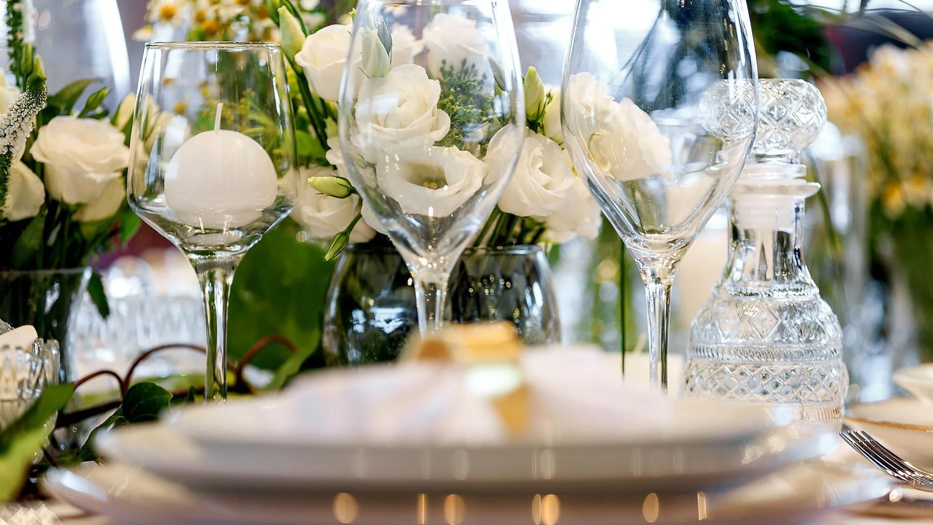 a table with many glasses and flowers aboard ZEN Yacht for Sale