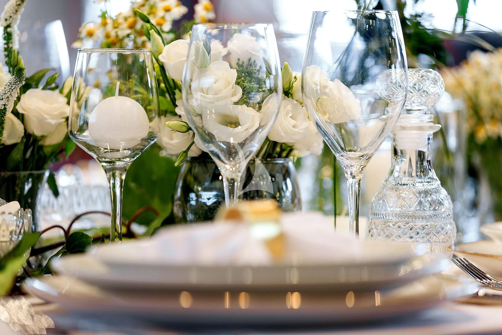 a group of white roses in a vase on a table aboard ZEN Yacht for Sale