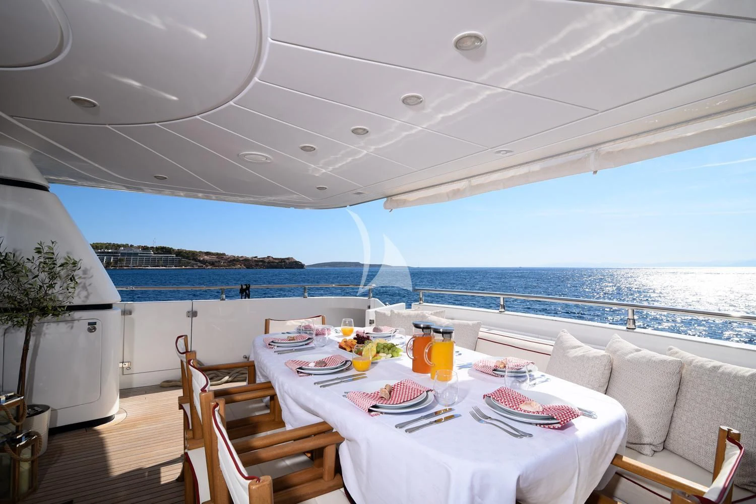 a table set for a meal on a balcony overlooking the ocean aboard ZEN Yacht for Sale
