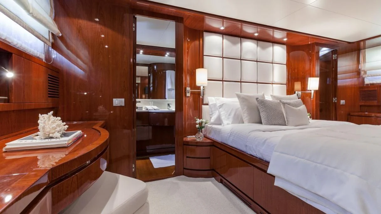 a room with a bed and a desk aboard ZEN Yacht for Sale
