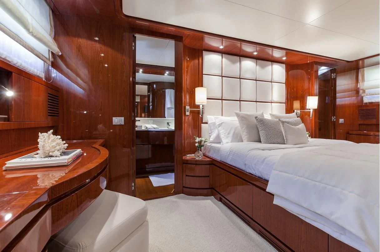 a room with a bed and a desk aboard ZEN Yacht for Sale