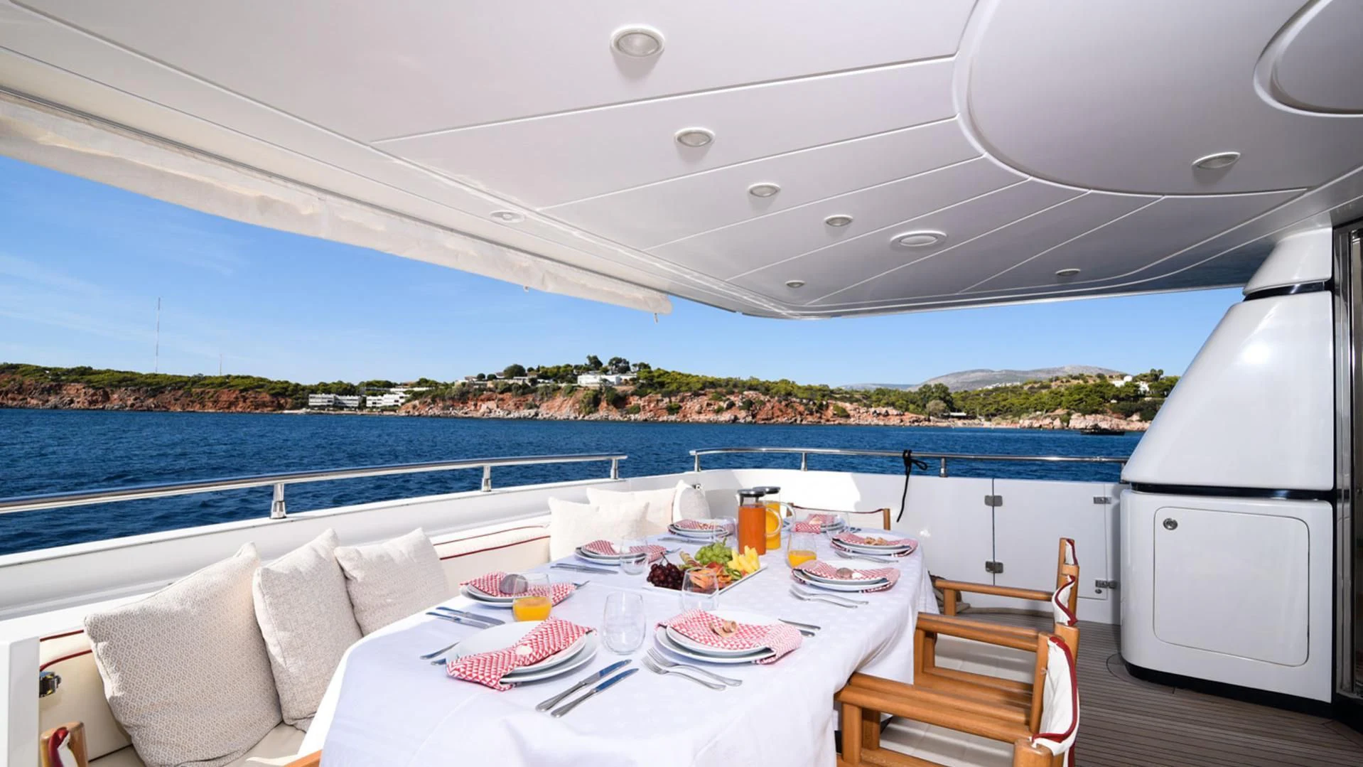 a table set for a meal on a deck overlooking the ocean aboard ZEN Yacht for Sale