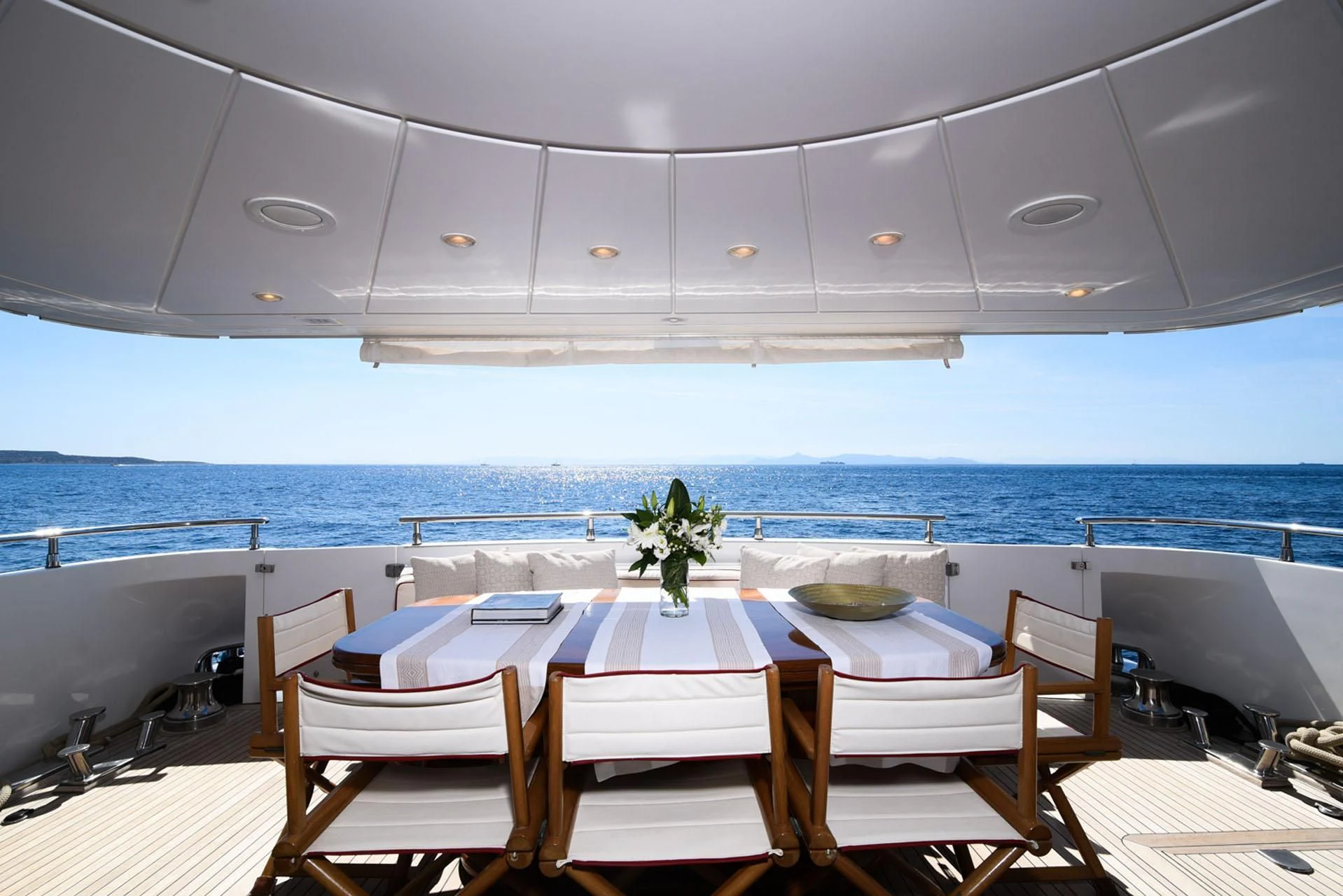 a table set for a meal on a deck overlooking the ocean aboard ZEN Yacht for Sale