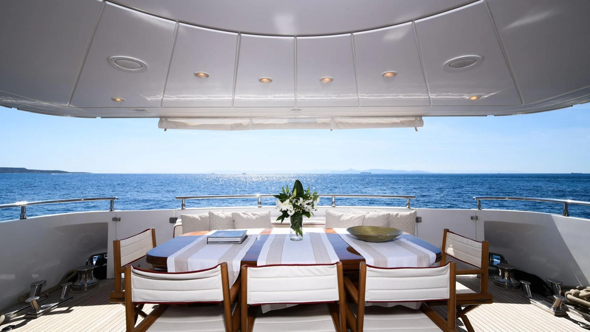 a table and chairs on a boat aboard ZEN Yacht for Sale