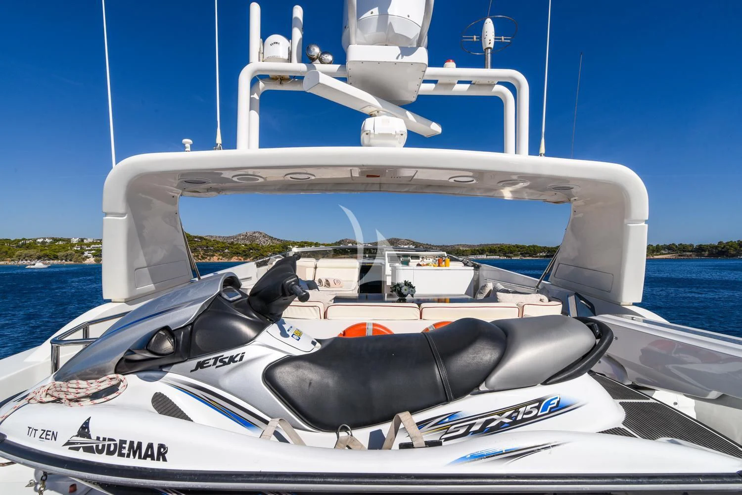 a white boat with a black and red steering wheel on a sunny day aboard ZEN Yacht for Sale