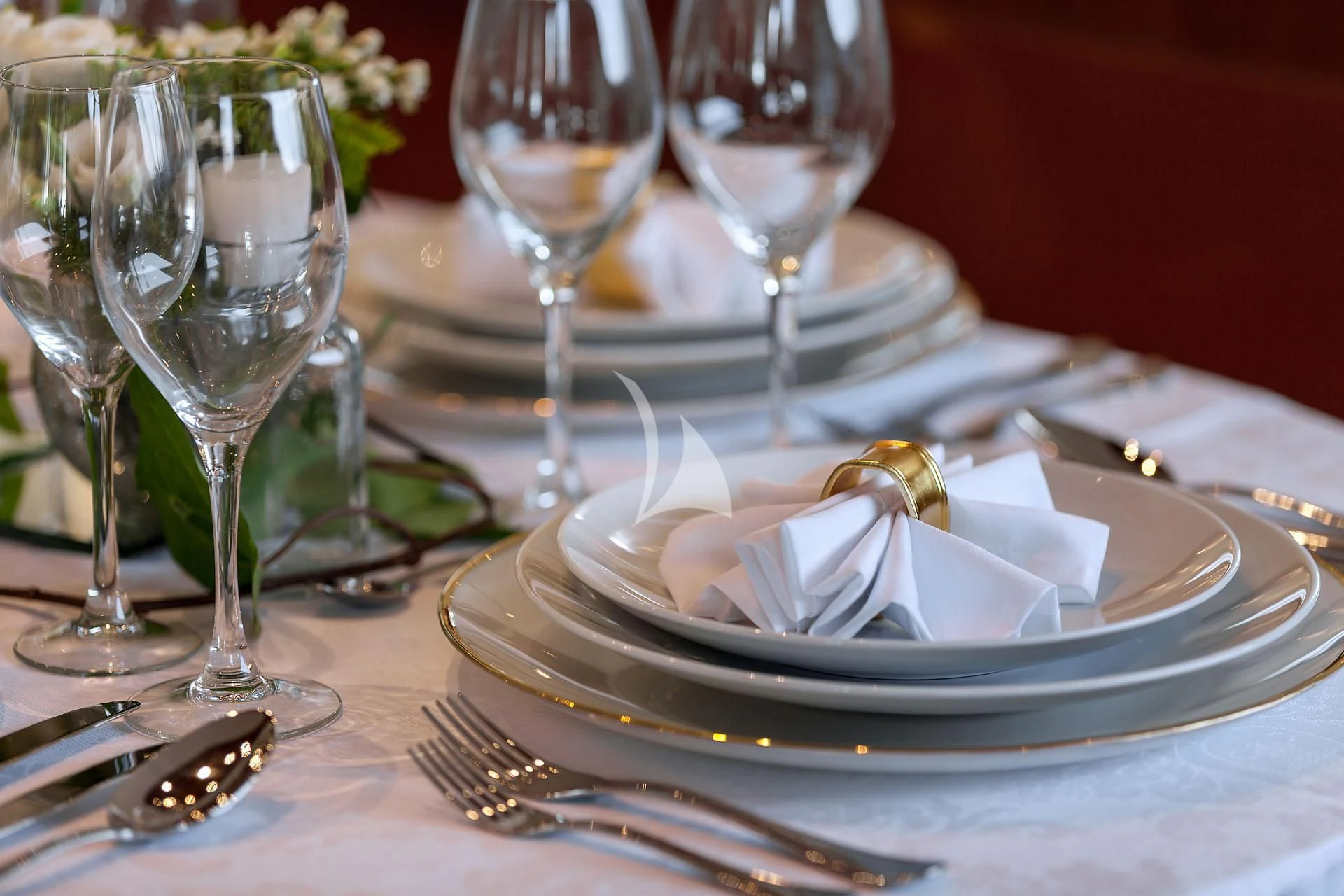 a plate of food and glasses aboard ZEN Yacht for Sale