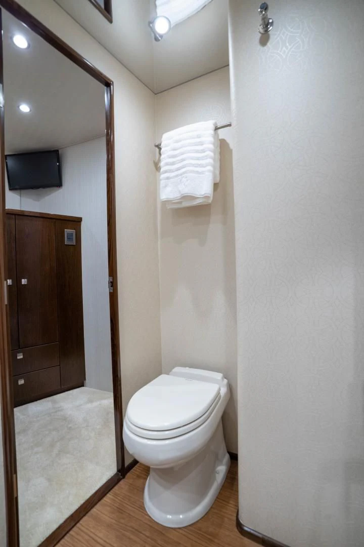 a bathroom with a toilet and a mirror aboard MER SEA SAKES Yacht for Sale