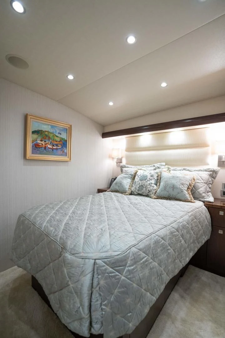 a bed with a white comforter aboard MER SEA SAKES Yacht for Sale