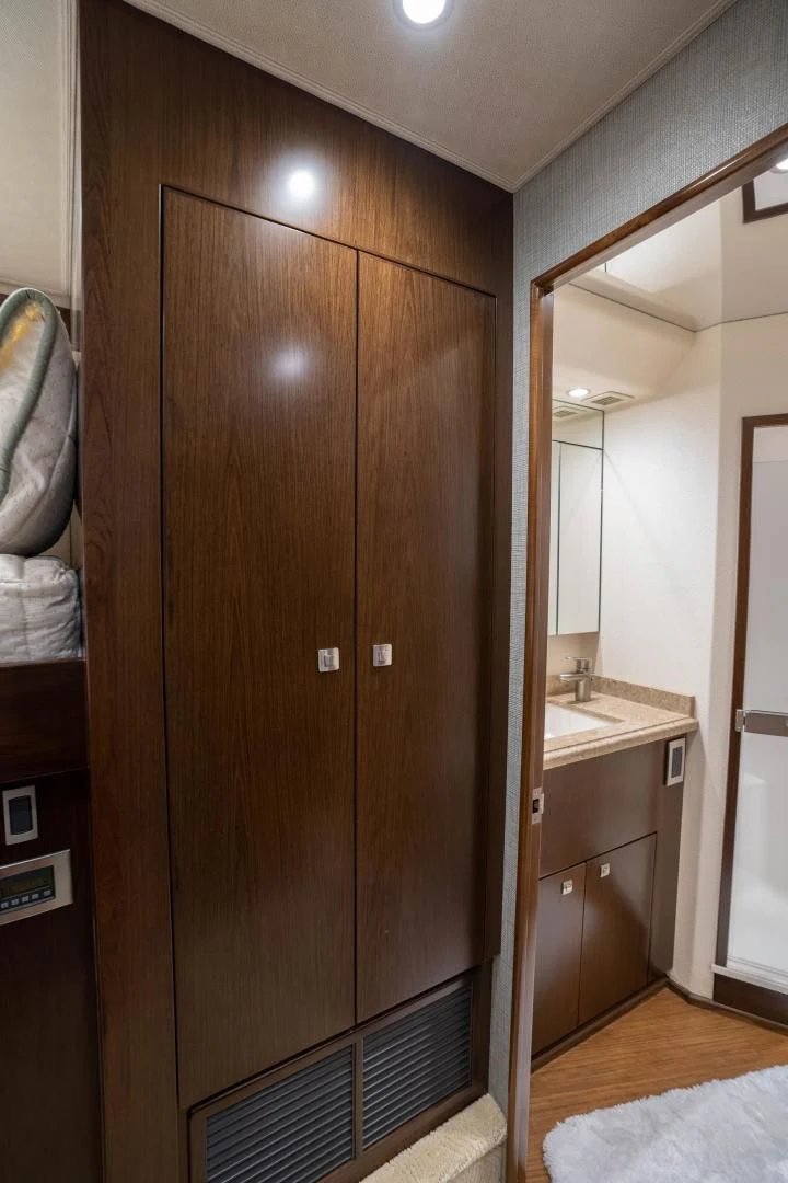 a bathroom with a wood door aboard MER SEA SAKES Yacht for Sale