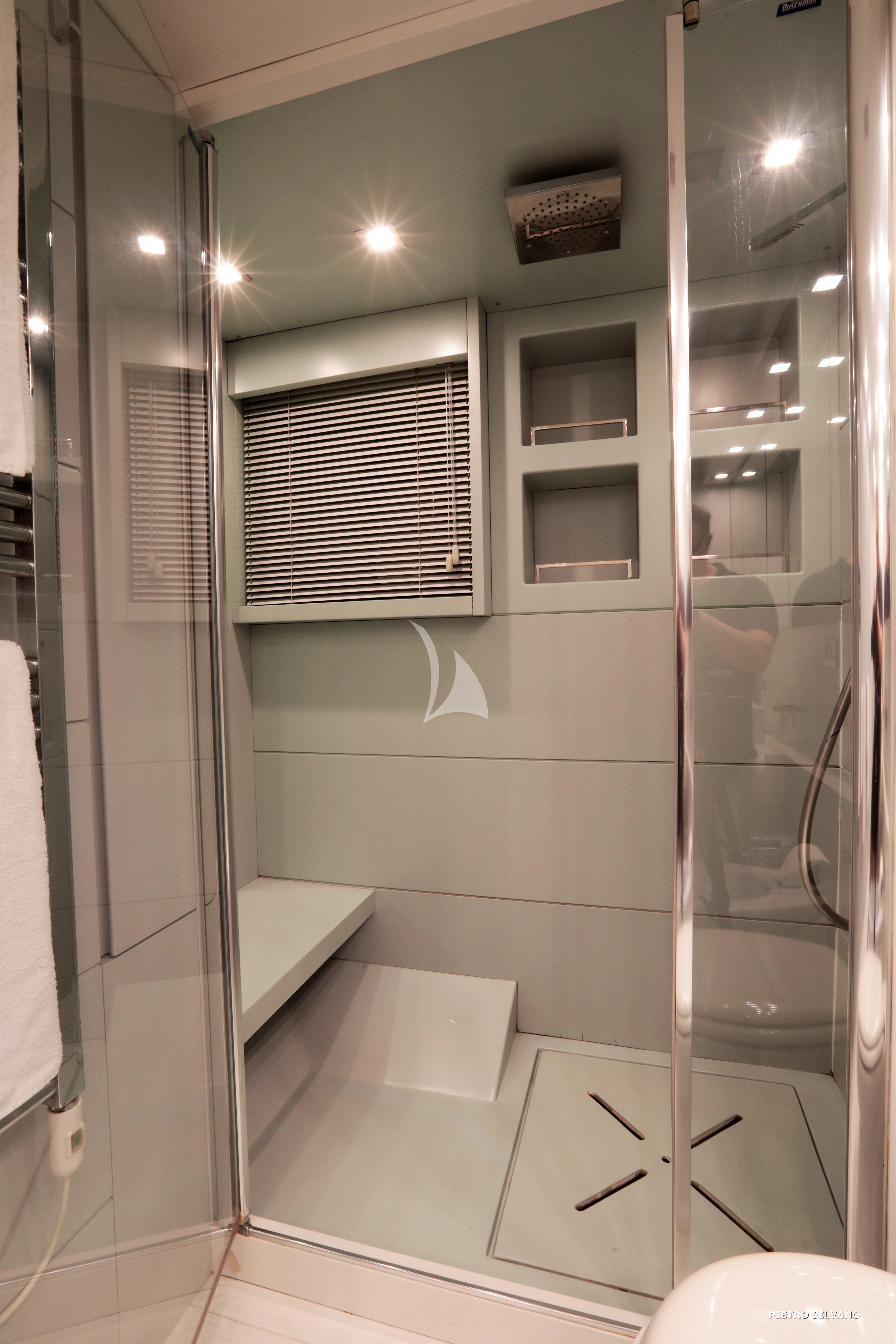 a bathroom with a glass shower aboard NIKCA Yacht for Sale