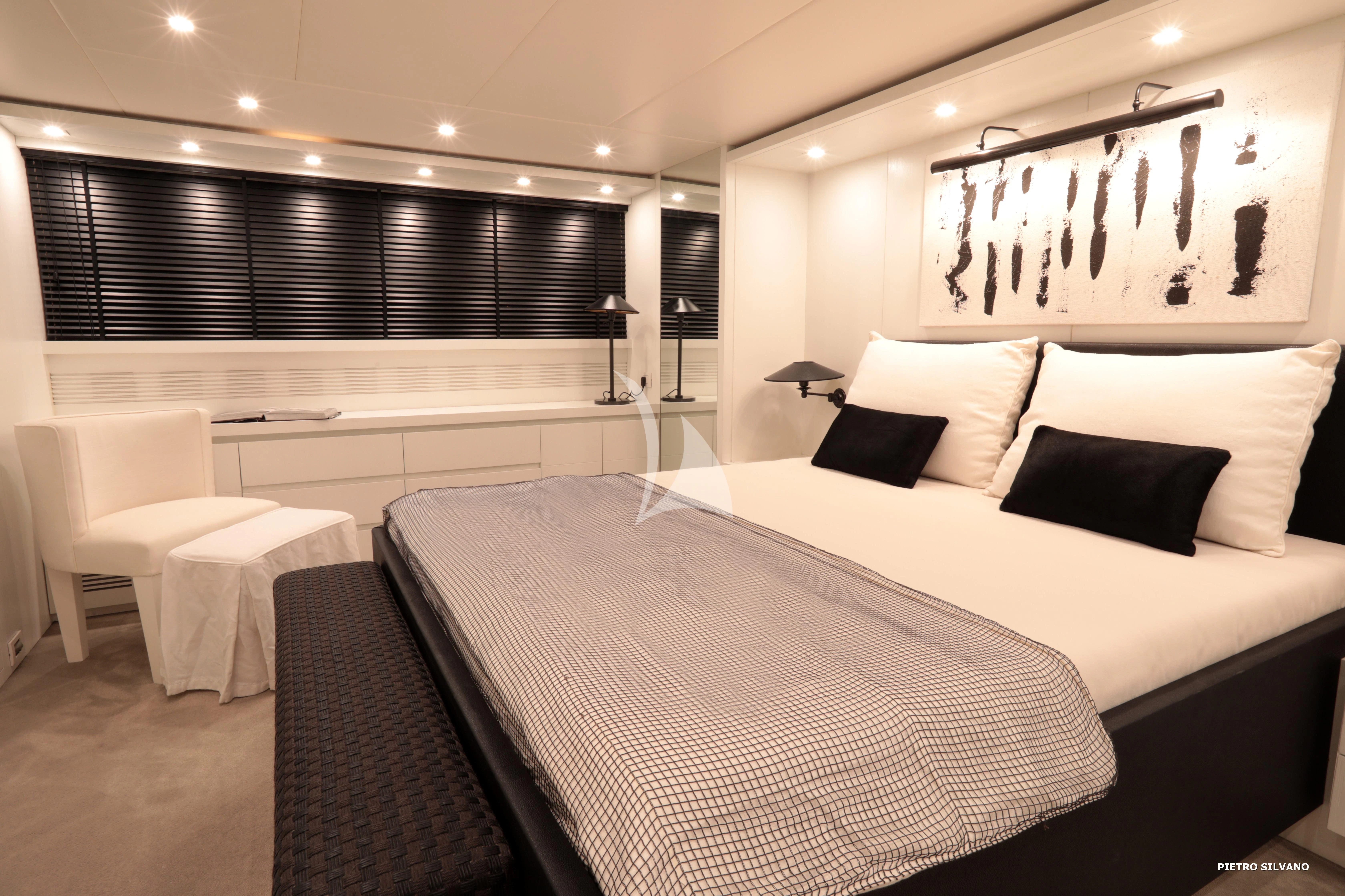 a room with a bed and a desk aboard NIKCA Yacht for Sale
