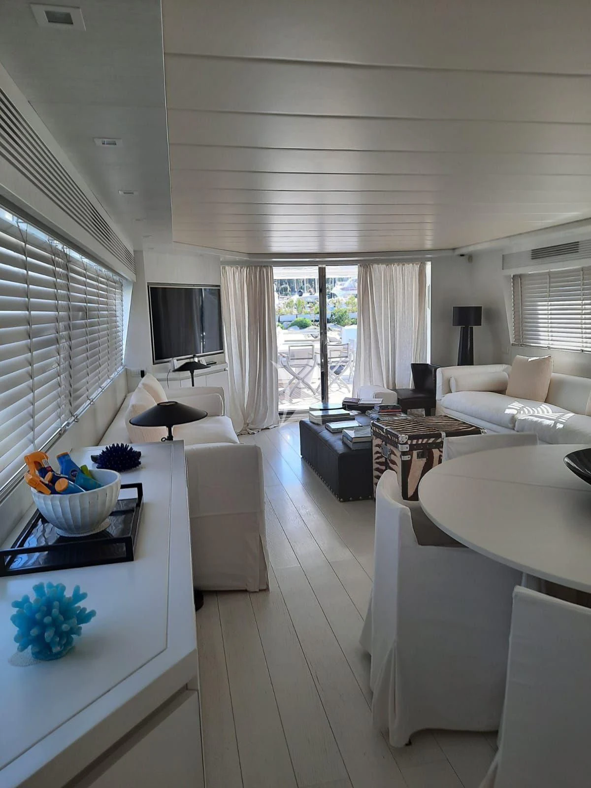 a room with a table chairs and a window aboard NIKCA Yacht for Sale