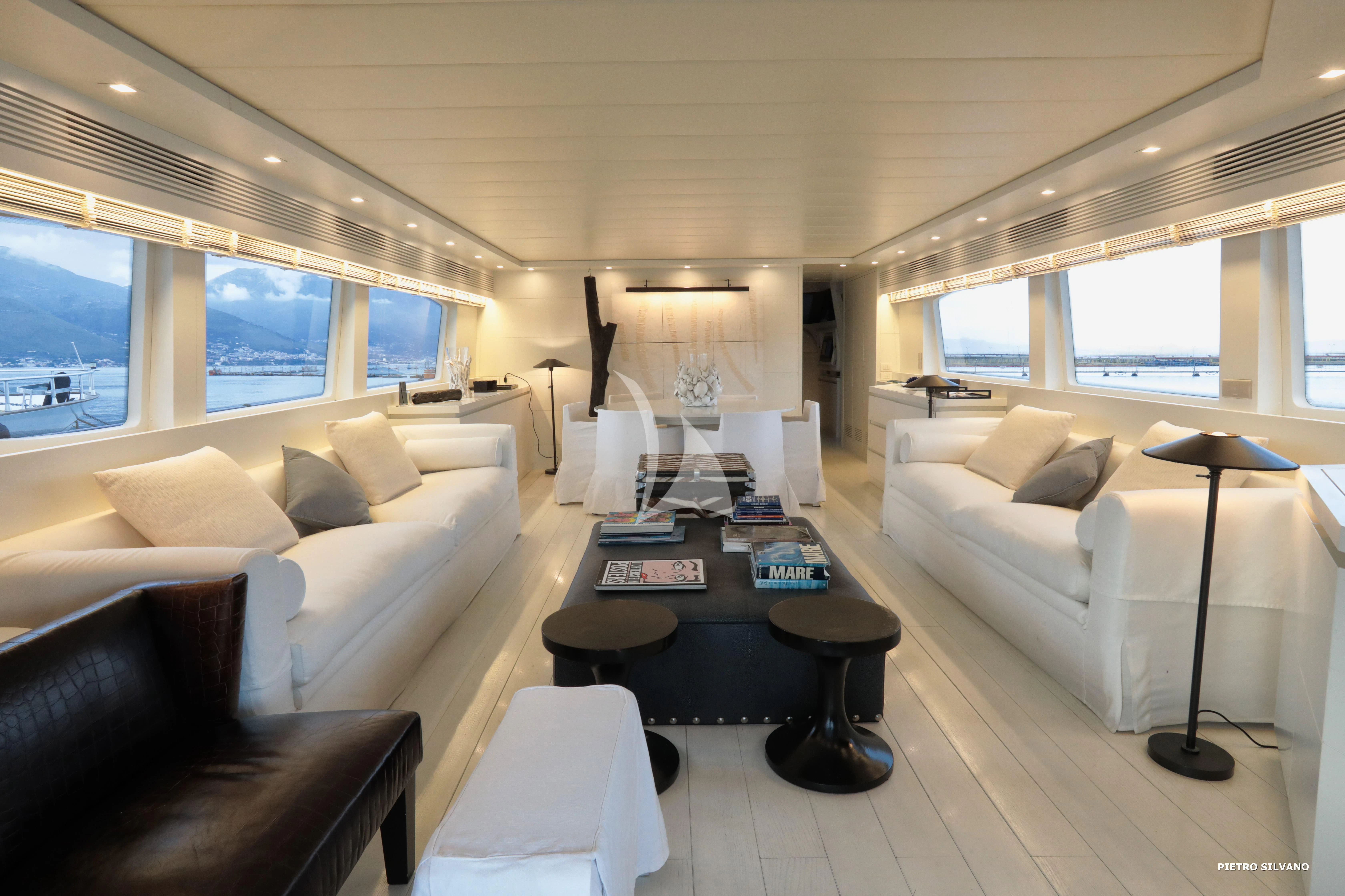 a living room with a couch and a table aboard NIKCA Yacht for Sale