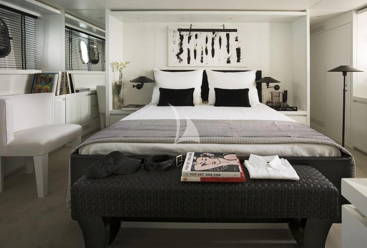 a bed with a black comforter aboard NIKCA Yacht for Sale
