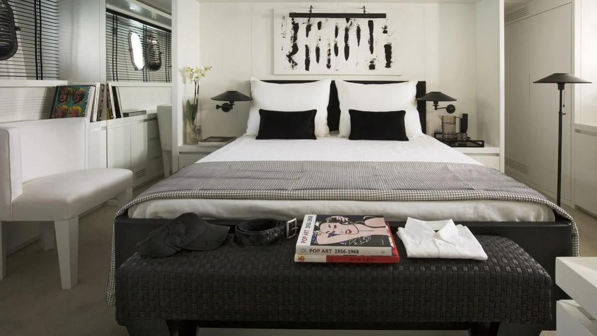 a bed with a book on it aboard NIKCA Yacht for Sale