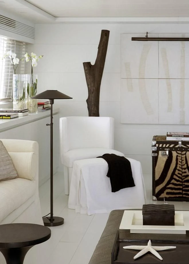 a room with a chair and a table and a fireplace aboard NIKCA Yacht for Sale