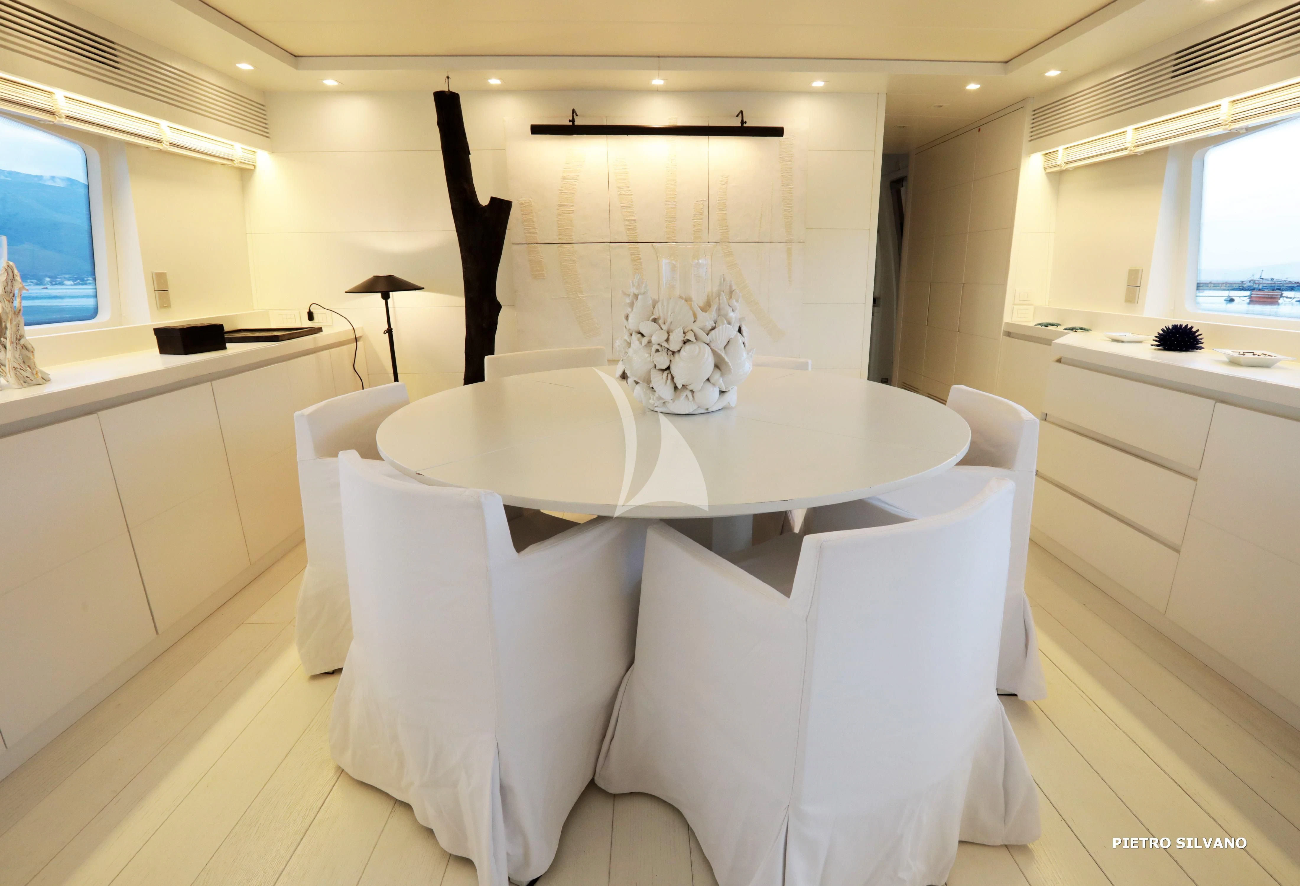 a white dining table in a room aboard NIKCA Yacht for Sale