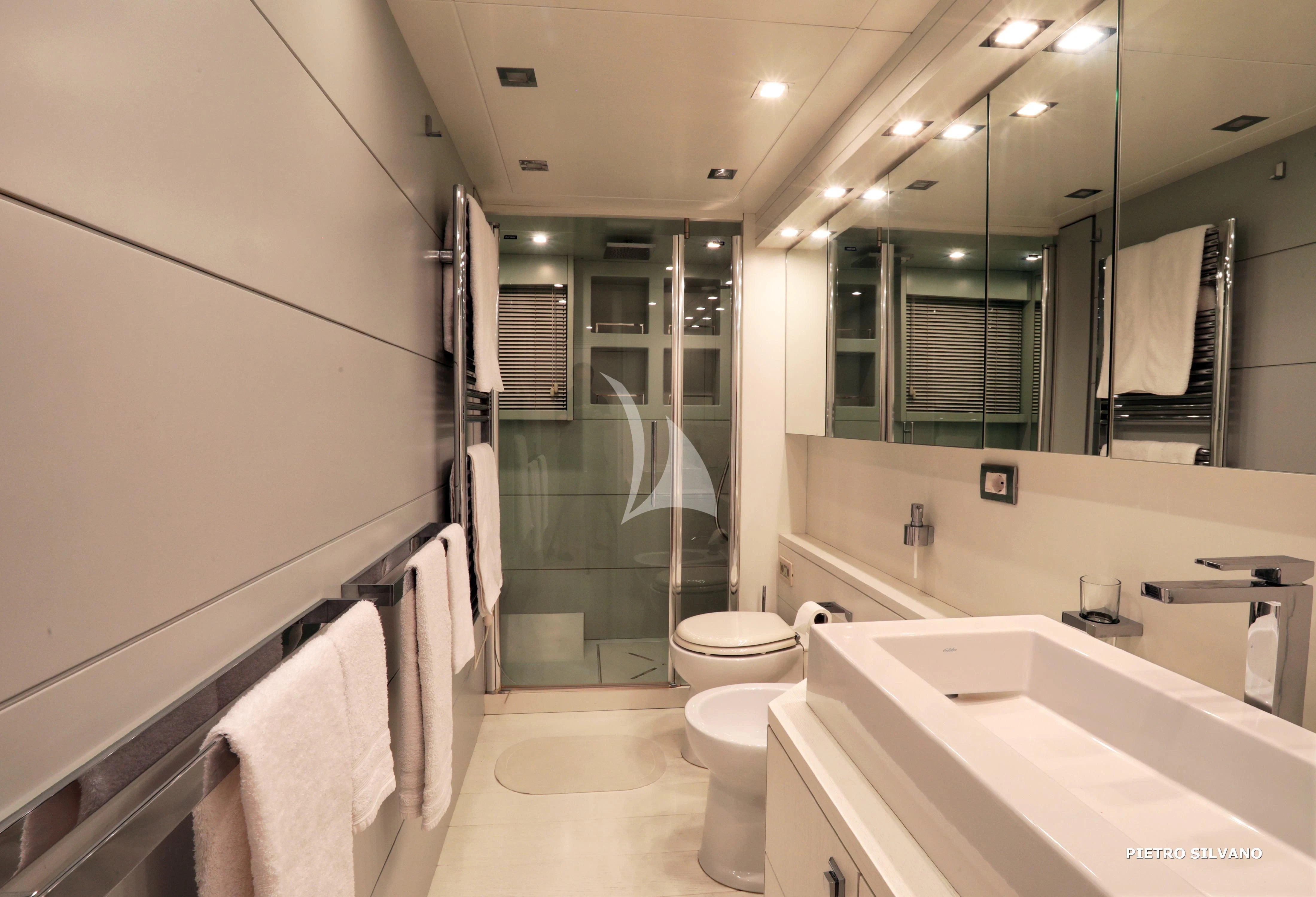 a bathroom with a glass shower aboard NIKCA Yacht for Sale