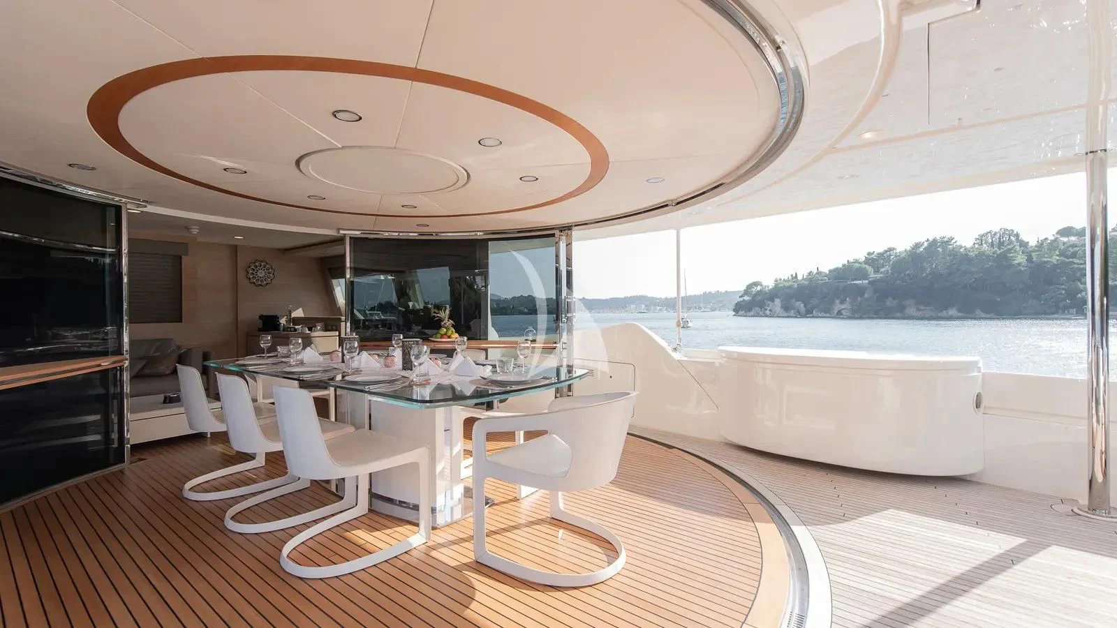 a room with a table chairs and a large window aboard DALOLI Yacht for Charter