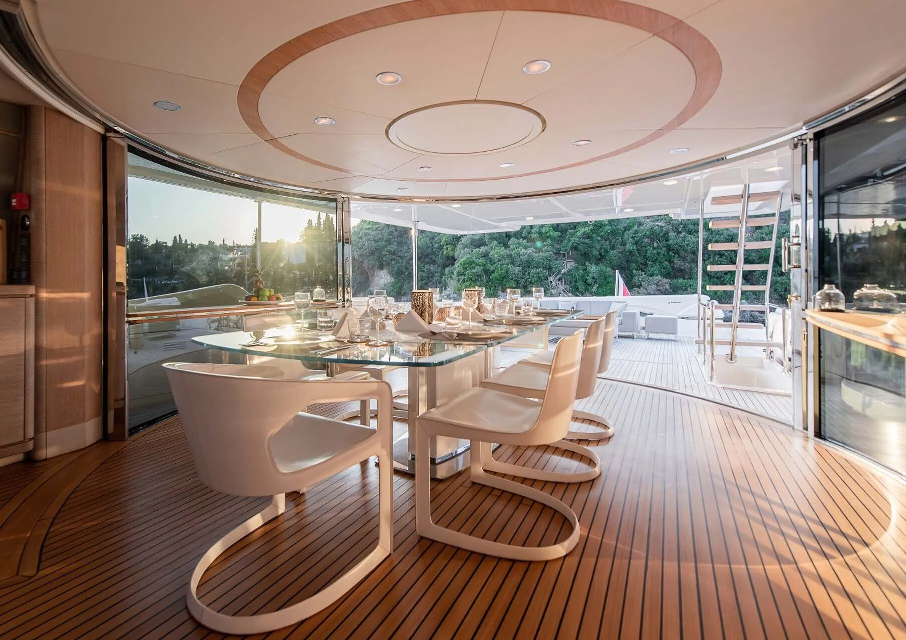a room with a table chairs and a large window aboard DALOLI Yacht for Charter