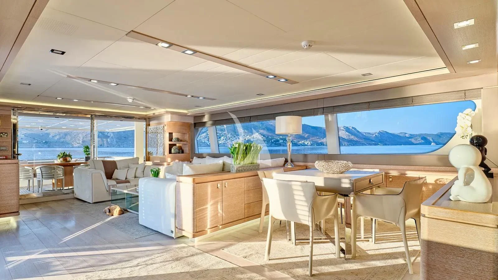a room with a table chairs and a large window aboard DALOLI Yacht for Charter