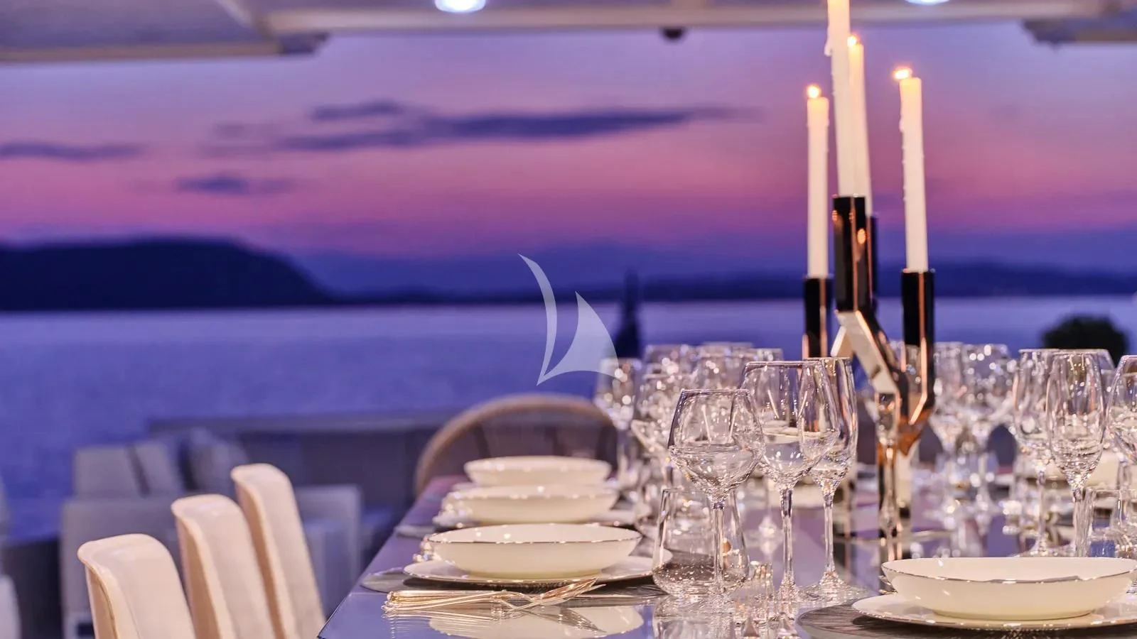 a table with plates and glasses on it aboard DALOLI Yacht for Charter
