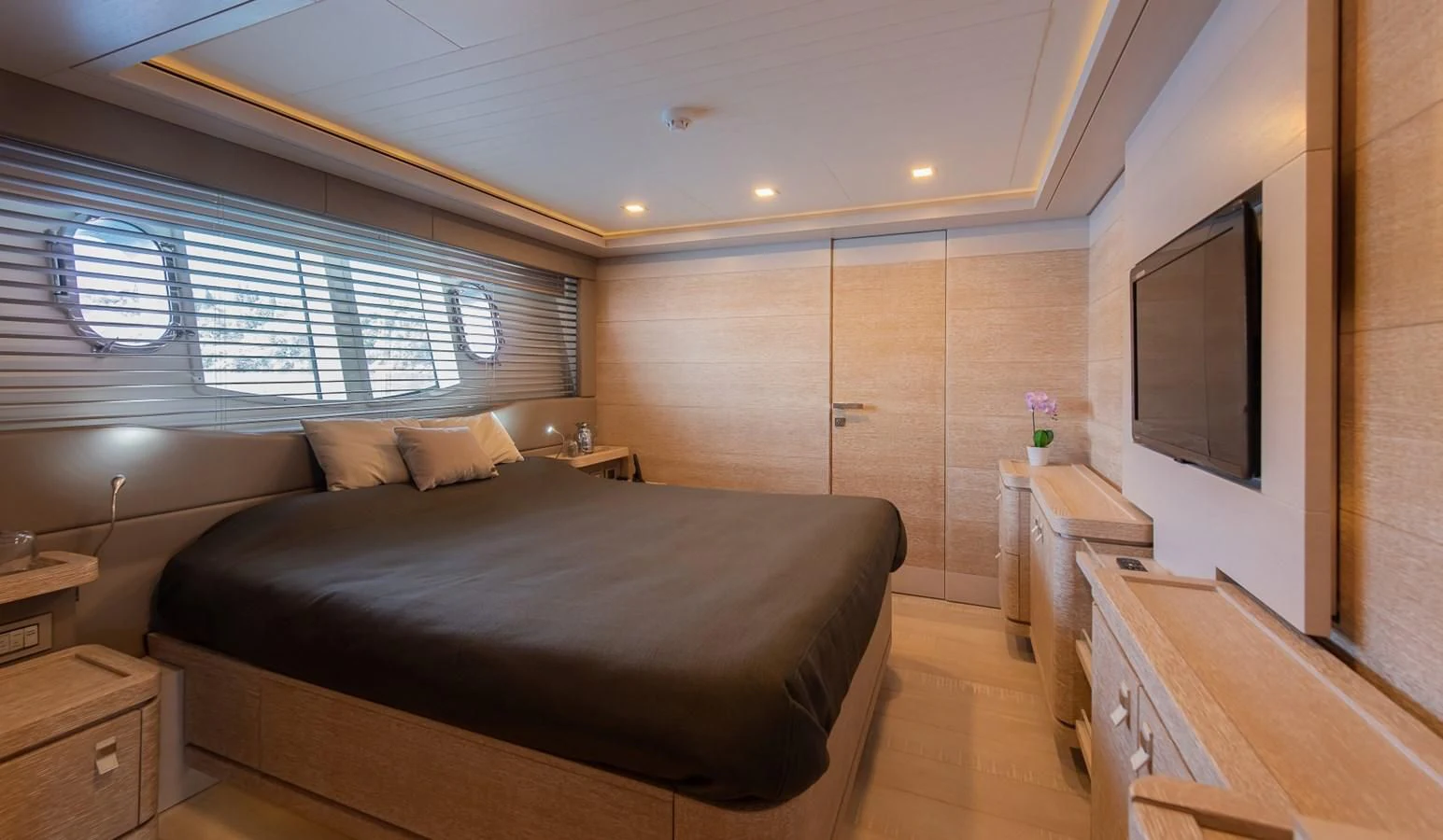 a bedroom with a bed and a tv aboard DALOLI Yacht for Charter