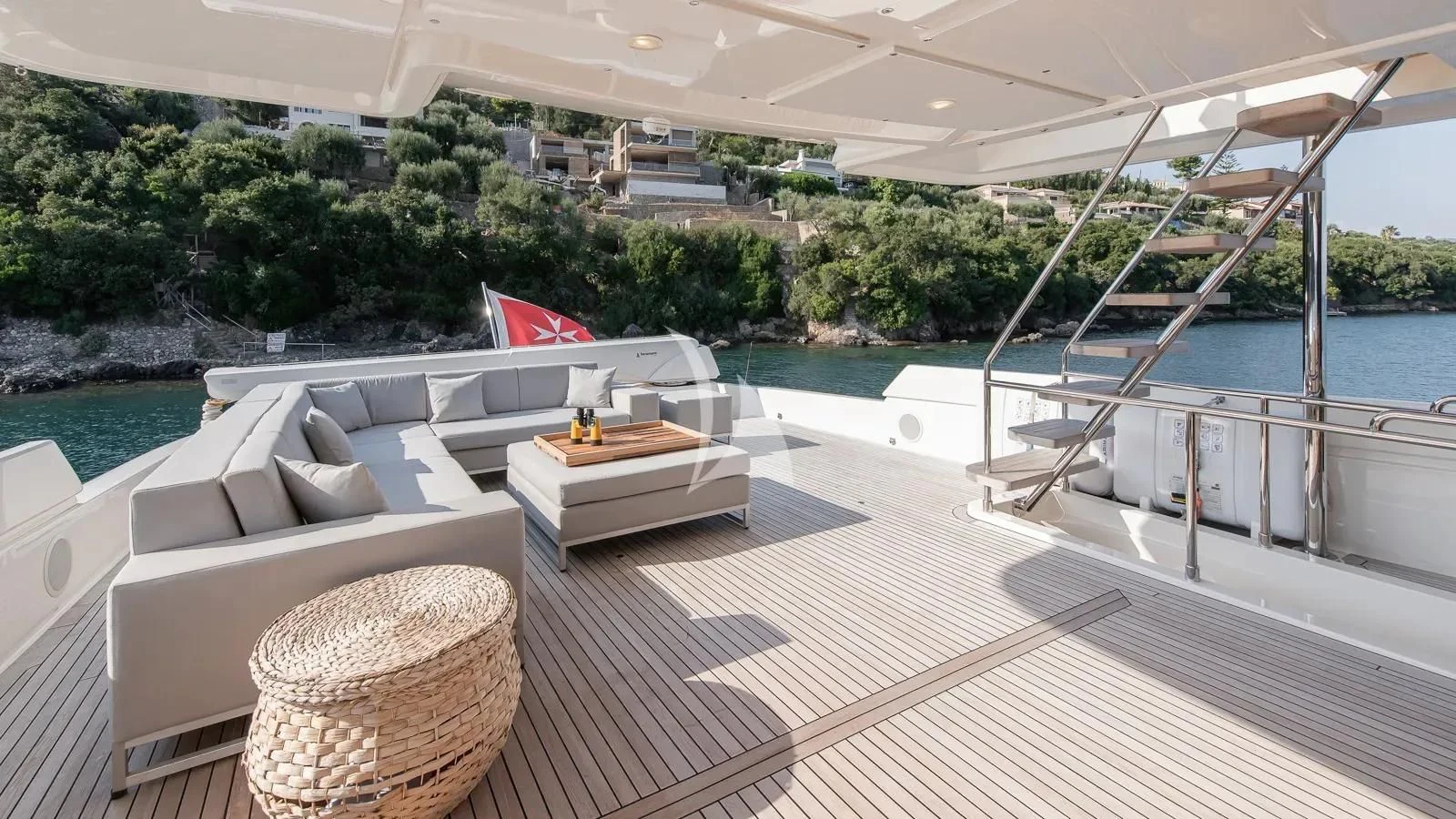 a deck with a table and chairs on it aboard DALOLI Yacht for Charter