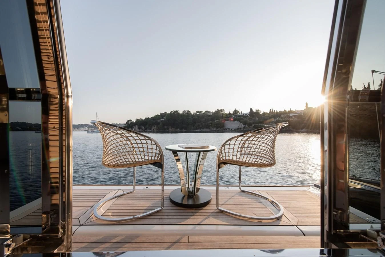 a couple chairs and a table by a window aboard DALOLI Yacht for Charter