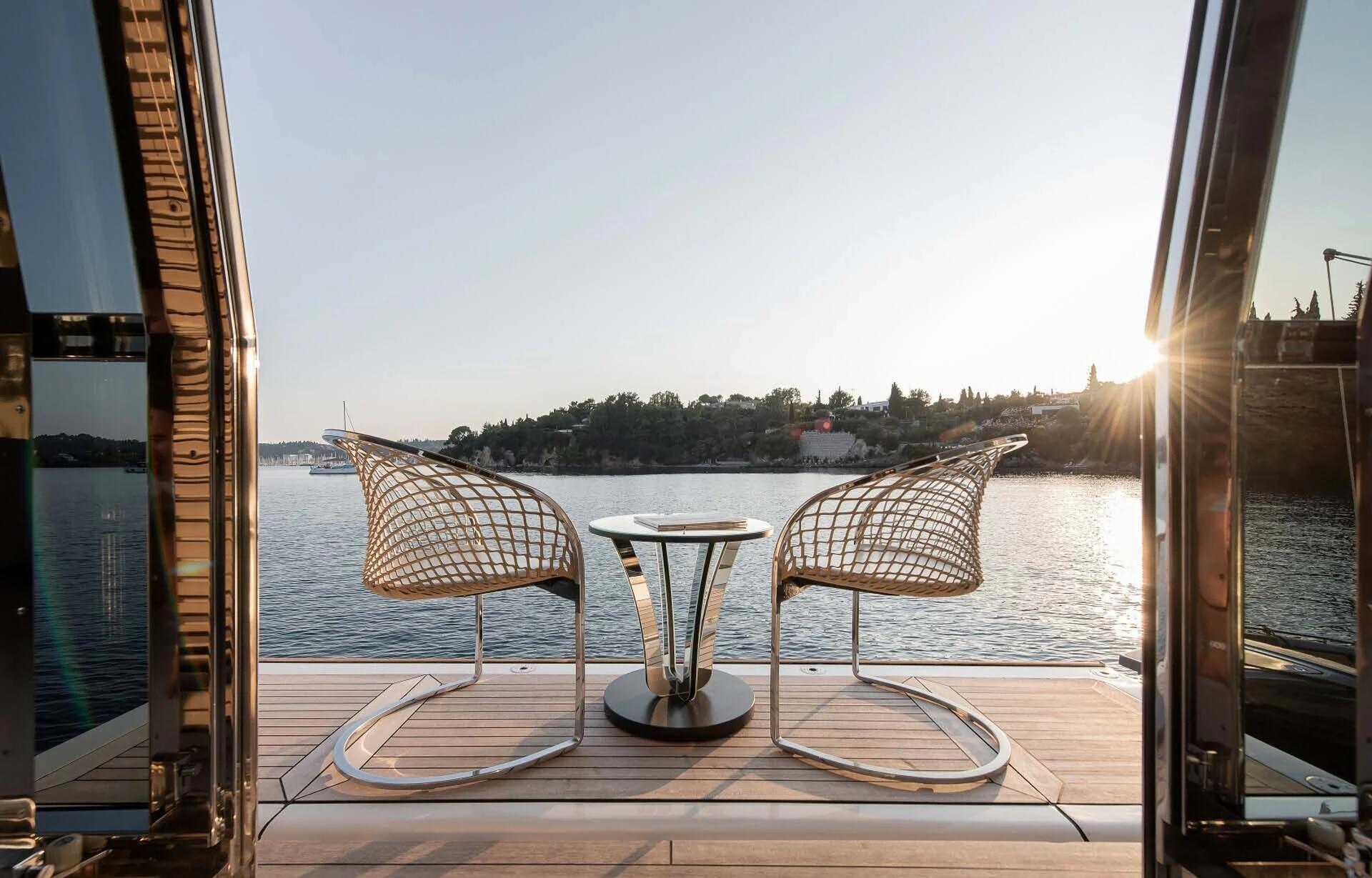 a table with chairs on it by a window with a view of a city aboard DALOLI Yacht for Charter