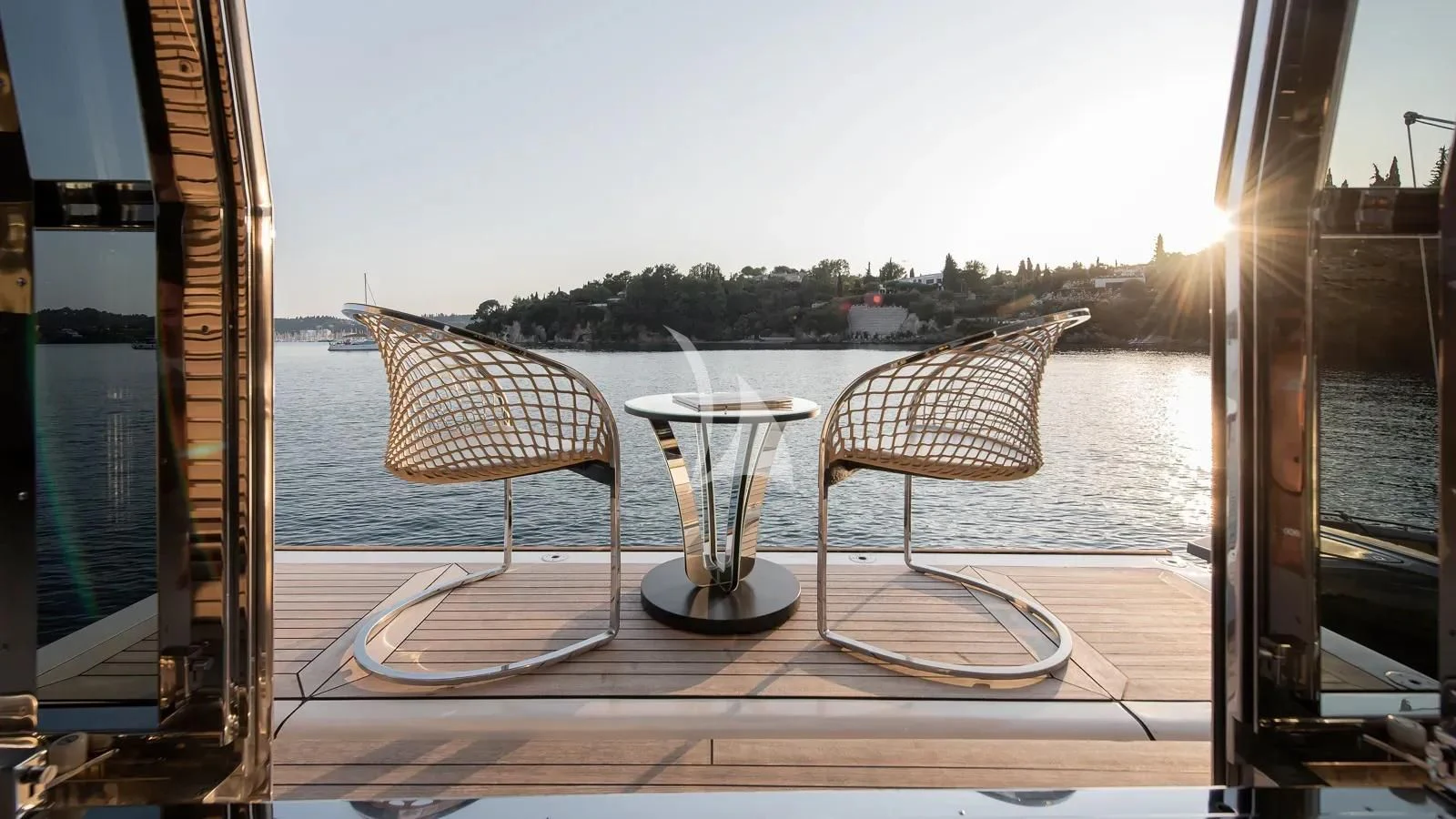 a table with chairs and umbrellas on it aboard DALOLI Yacht for Charter