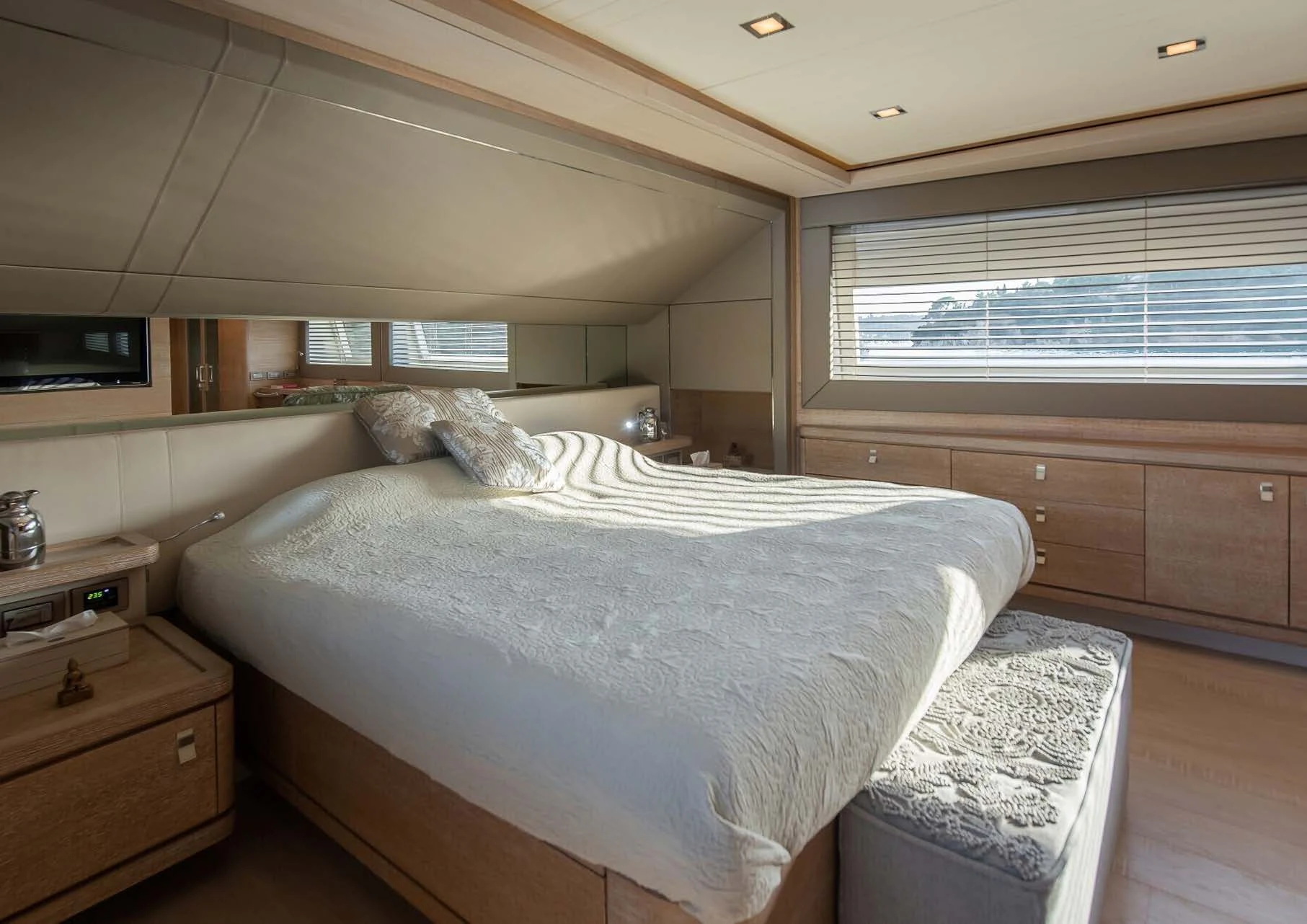 a bedroom with a bed and a dresser aboard DALOLI Yacht for Charter