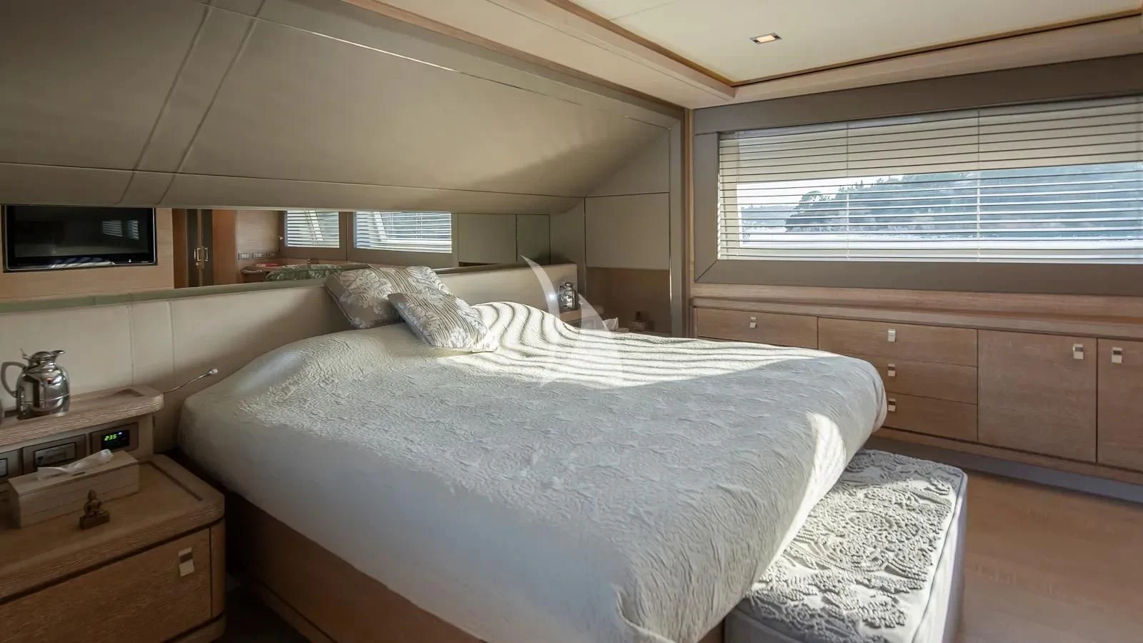 a room with a bed and a dresser aboard DALOLI Yacht for Charter