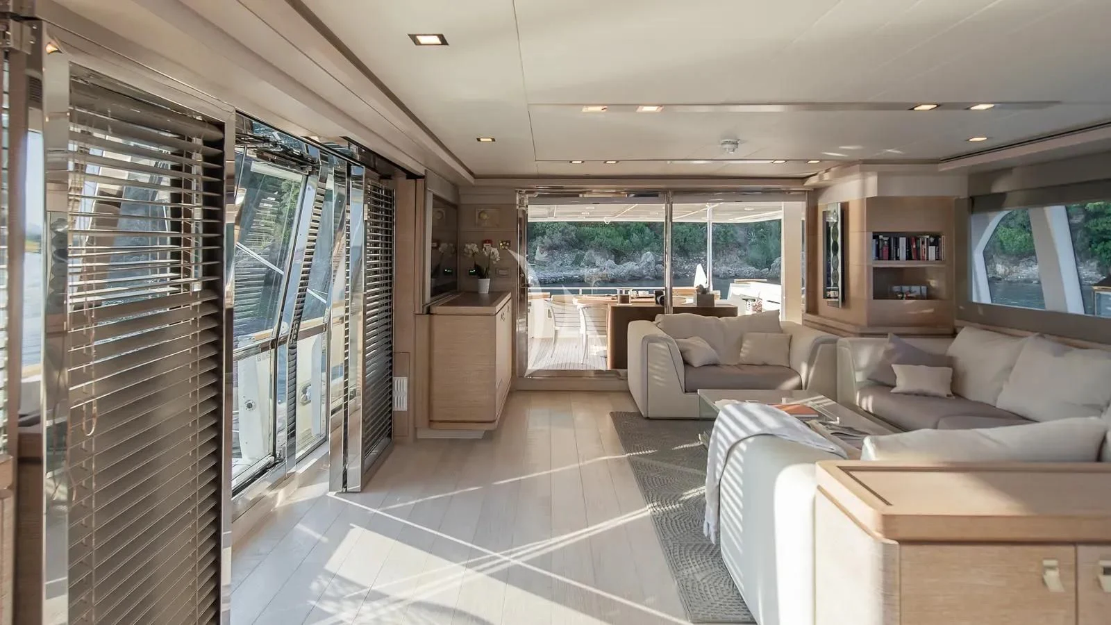 a room with a couch and a table and a tv aboard DALOLI Yacht for Charter