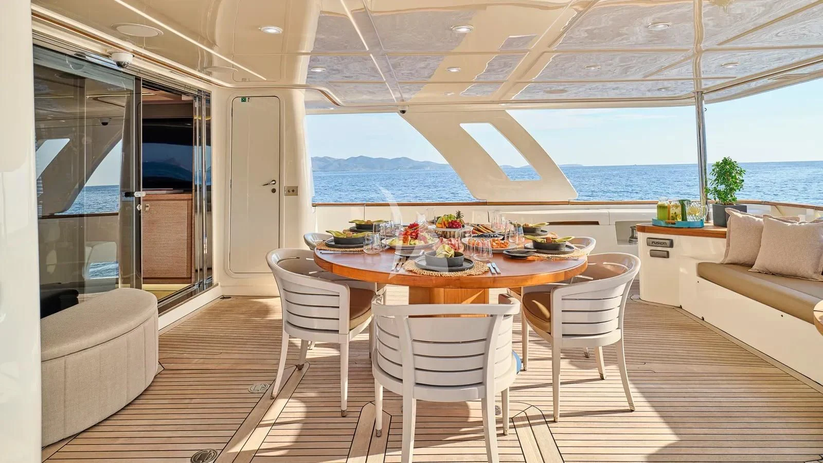 a large dining table in a room aboard DALOLI Yacht for Charter
