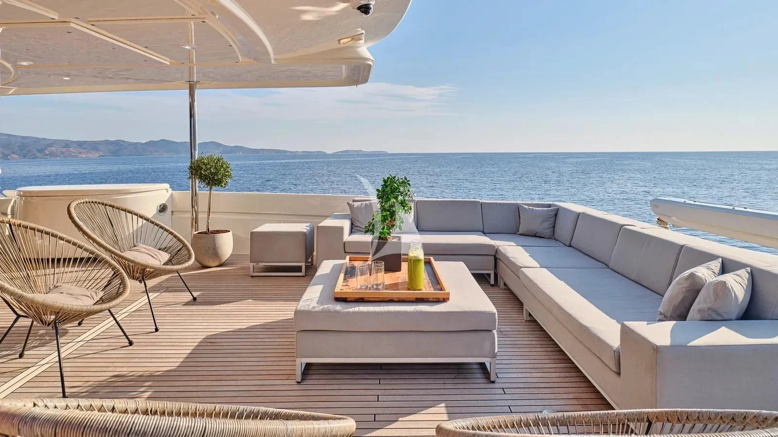 a patio with a table and chairs on it aboard DALOLI Yacht for Charter