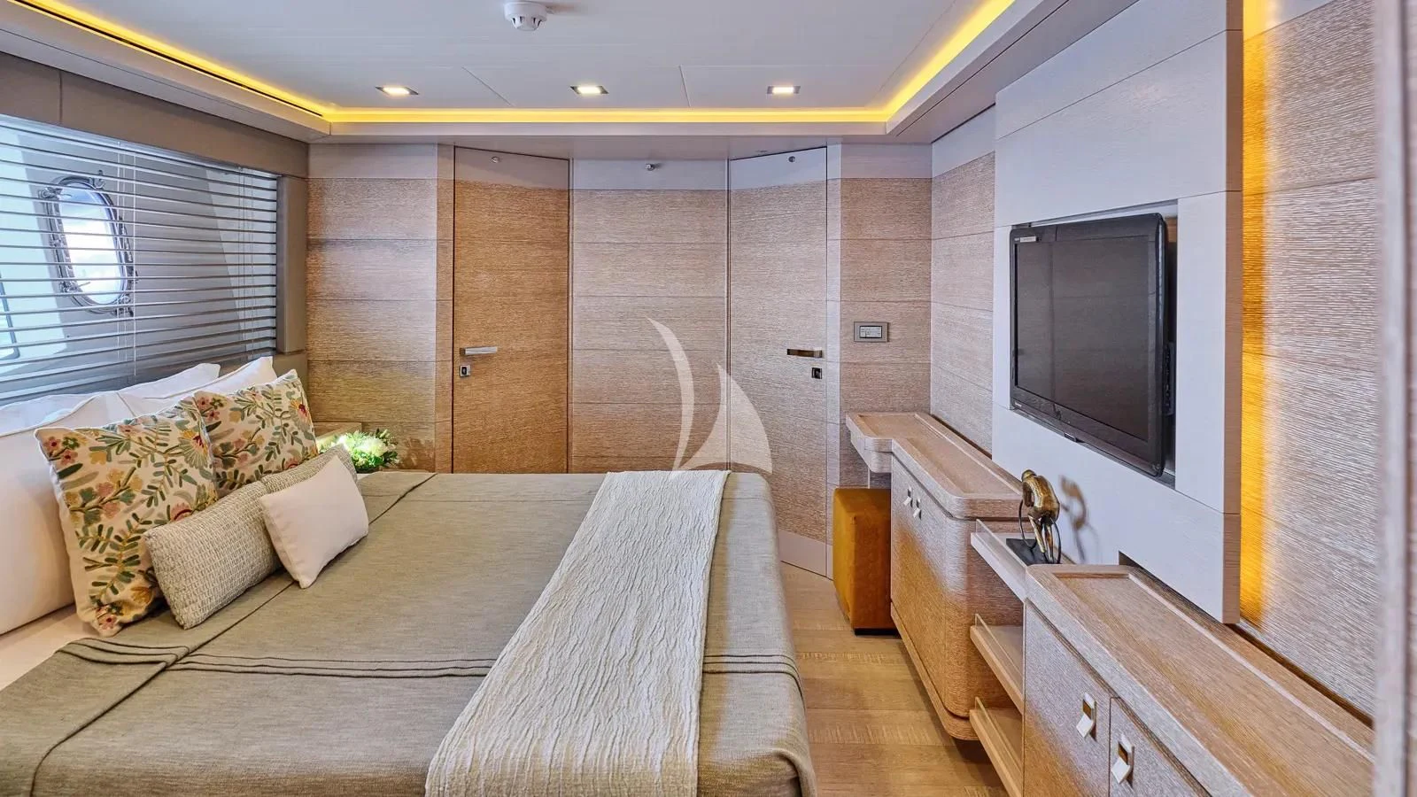 a bedroom with a bed and a tv aboard DALOLI Yacht for Charter