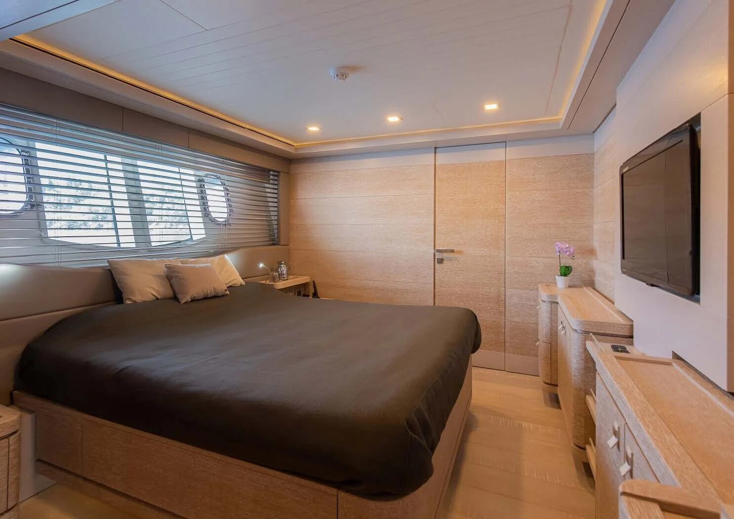 a bedroom with a bed and a tv aboard DALOLI Yacht for Charter
