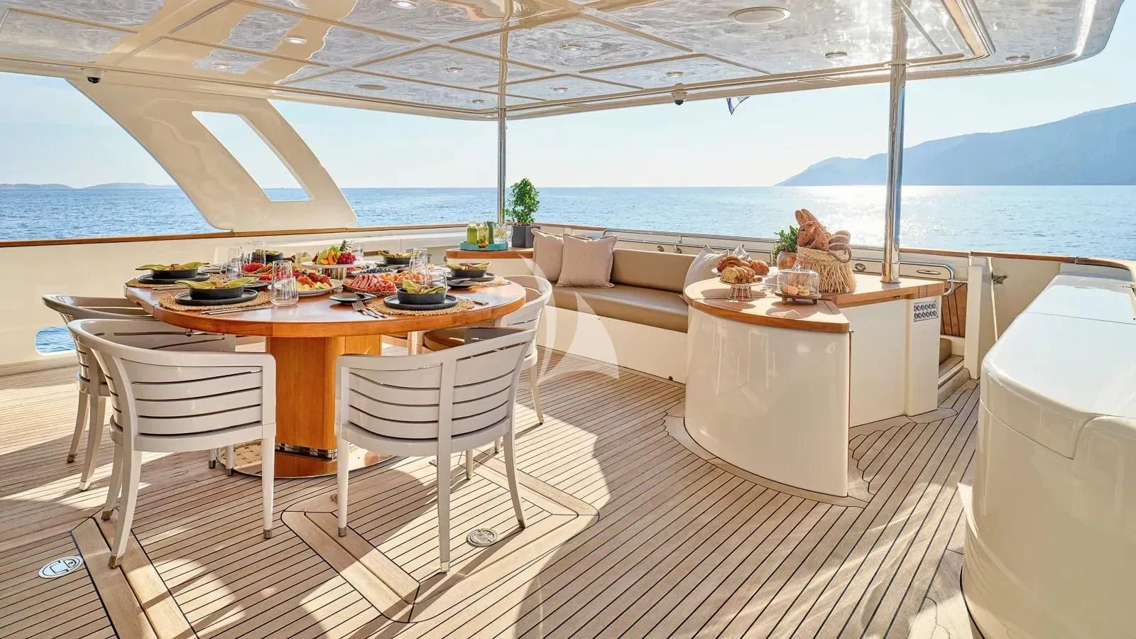 a table and chairs on a deck aboard DALOLI Yacht for Charter