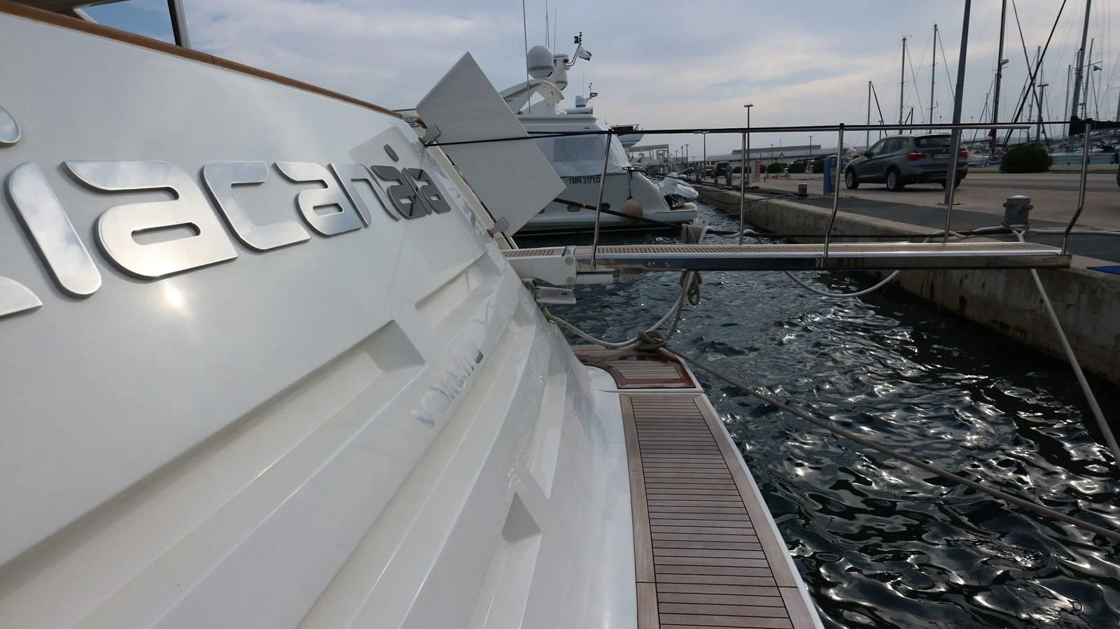 a white boat on a dock aboard DALOLI Yacht for Charter
