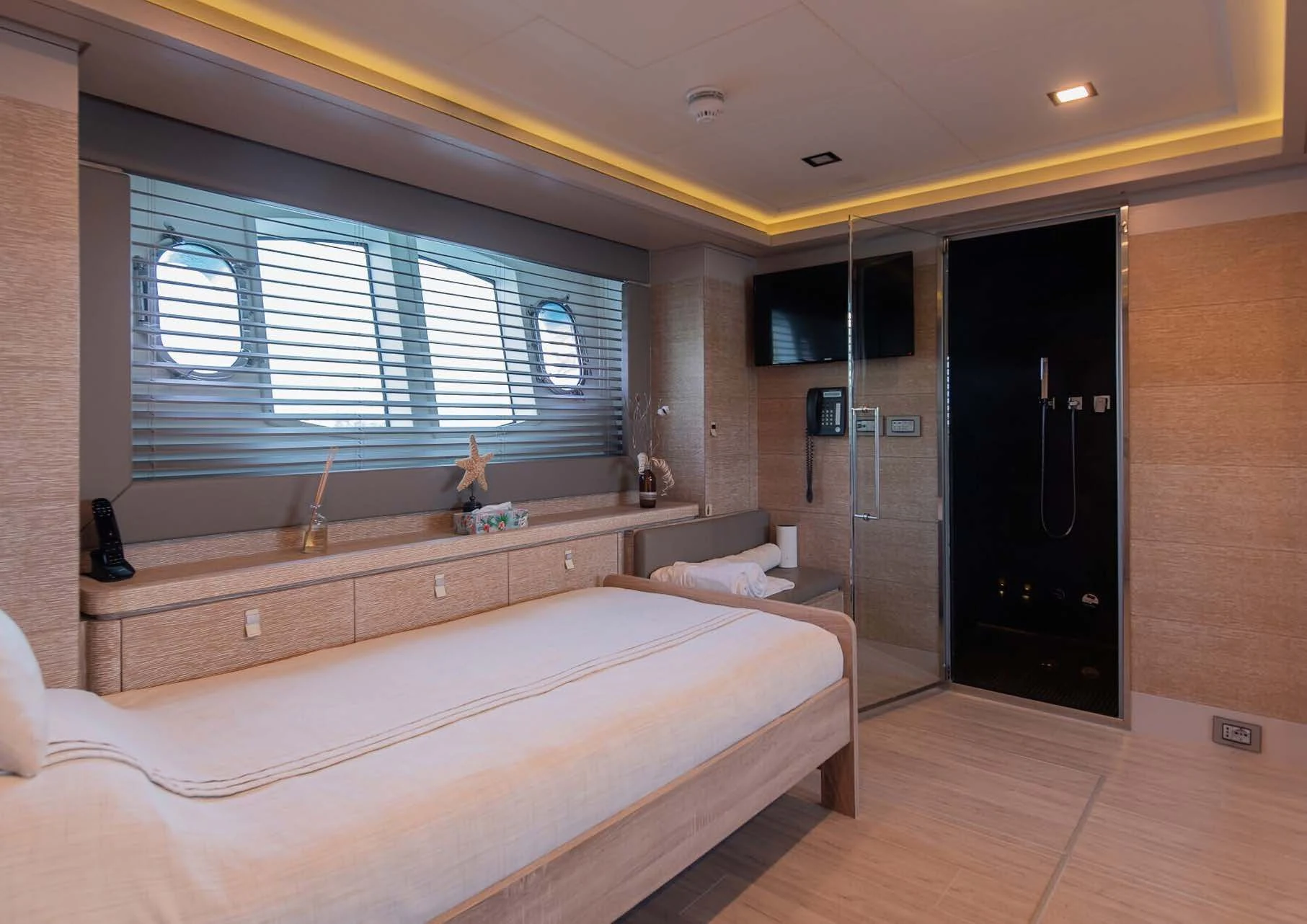 a room with a bed and a window aboard DALOLI Yacht for Charter