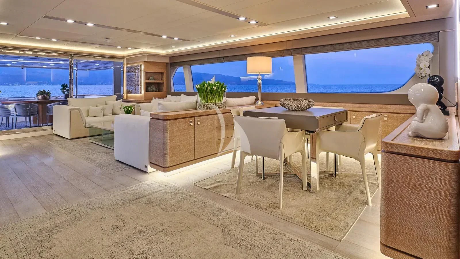 a room with a table chairs and a large window aboard DALOLI Yacht for Charter