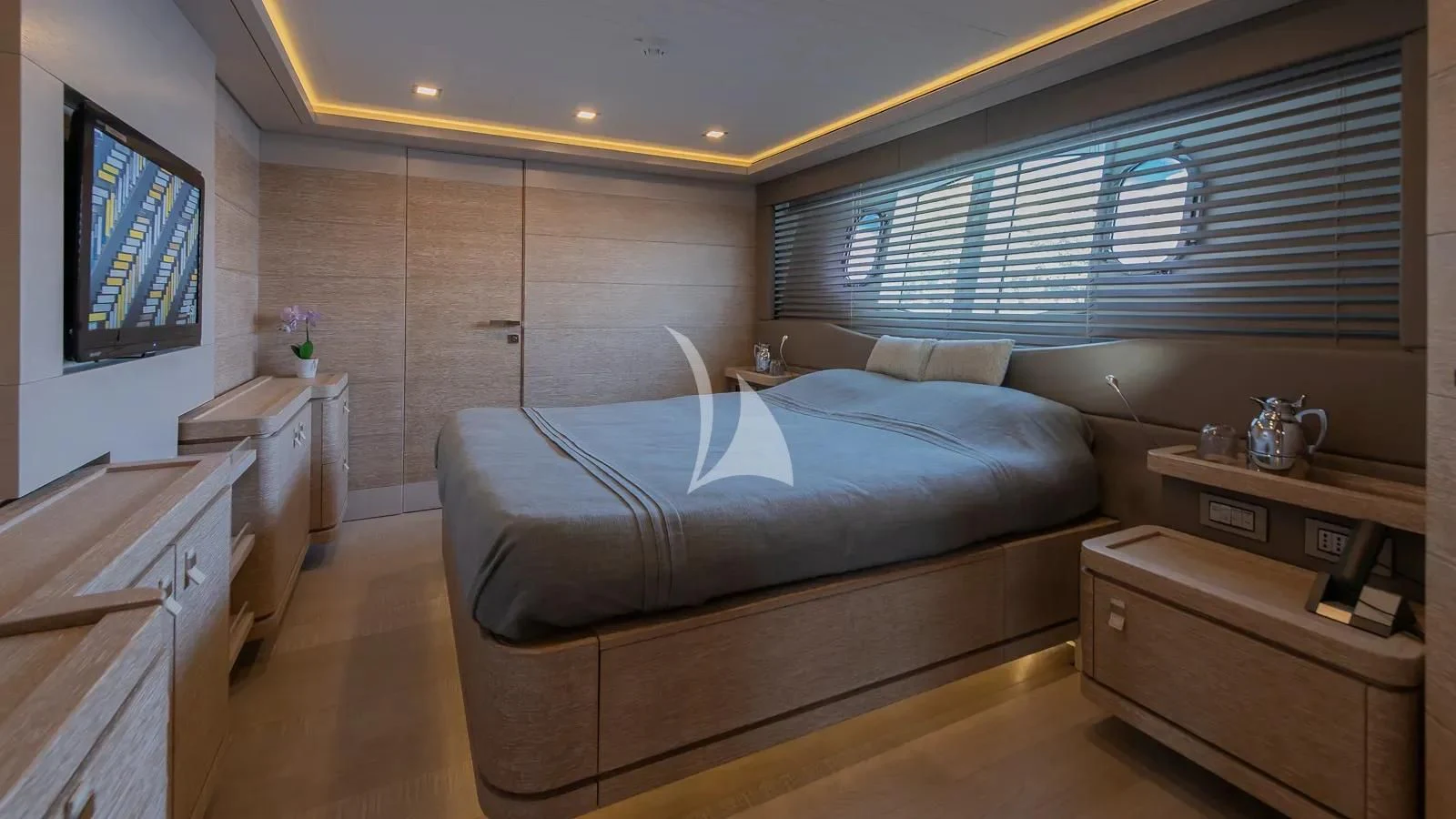 a bedroom with a bed and a tv aboard DALOLI Yacht for Charter