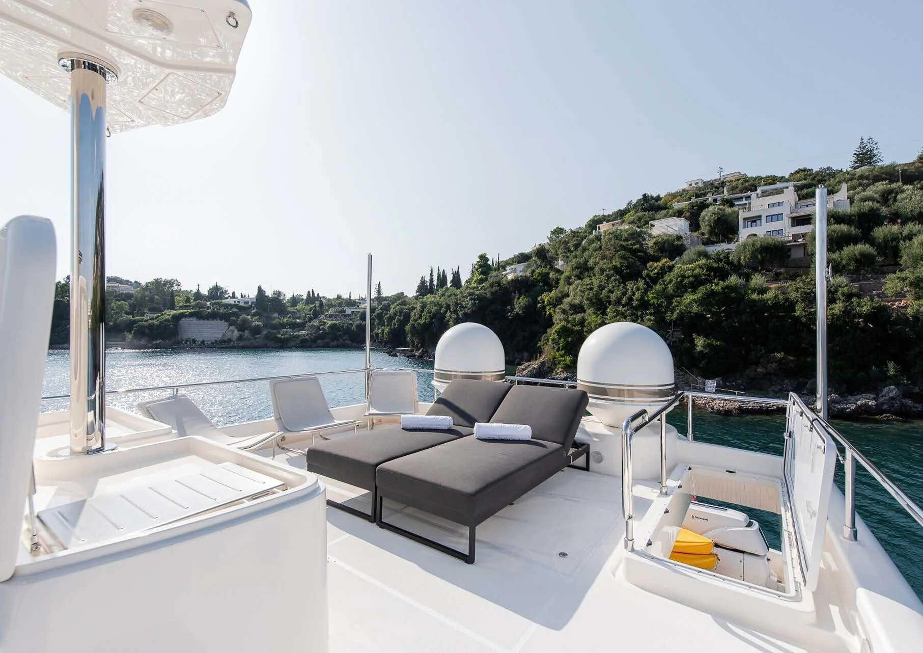 a deck with chairs and a body of water aboard DALOLI Yacht for Charter