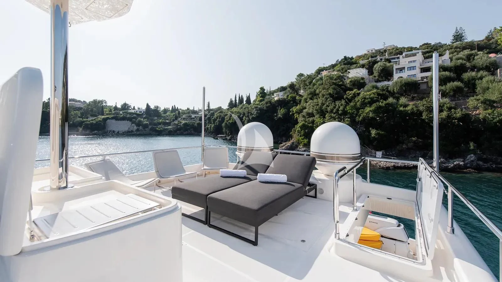 a deck with chairs and a body of water aboard DALOLI Yacht for Charter
